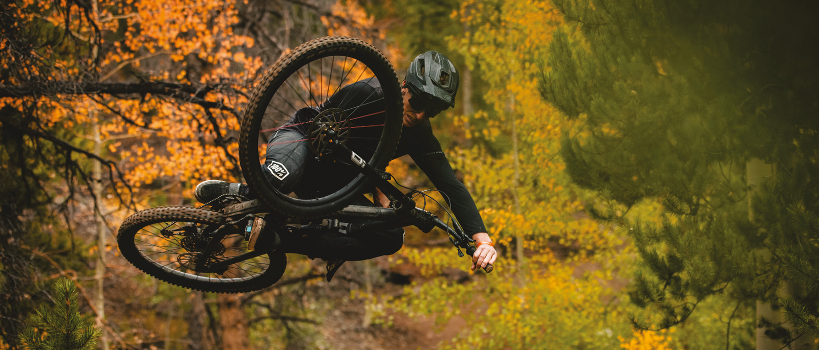 Rider doing table top jump on bike with Kenda mountain bike tires