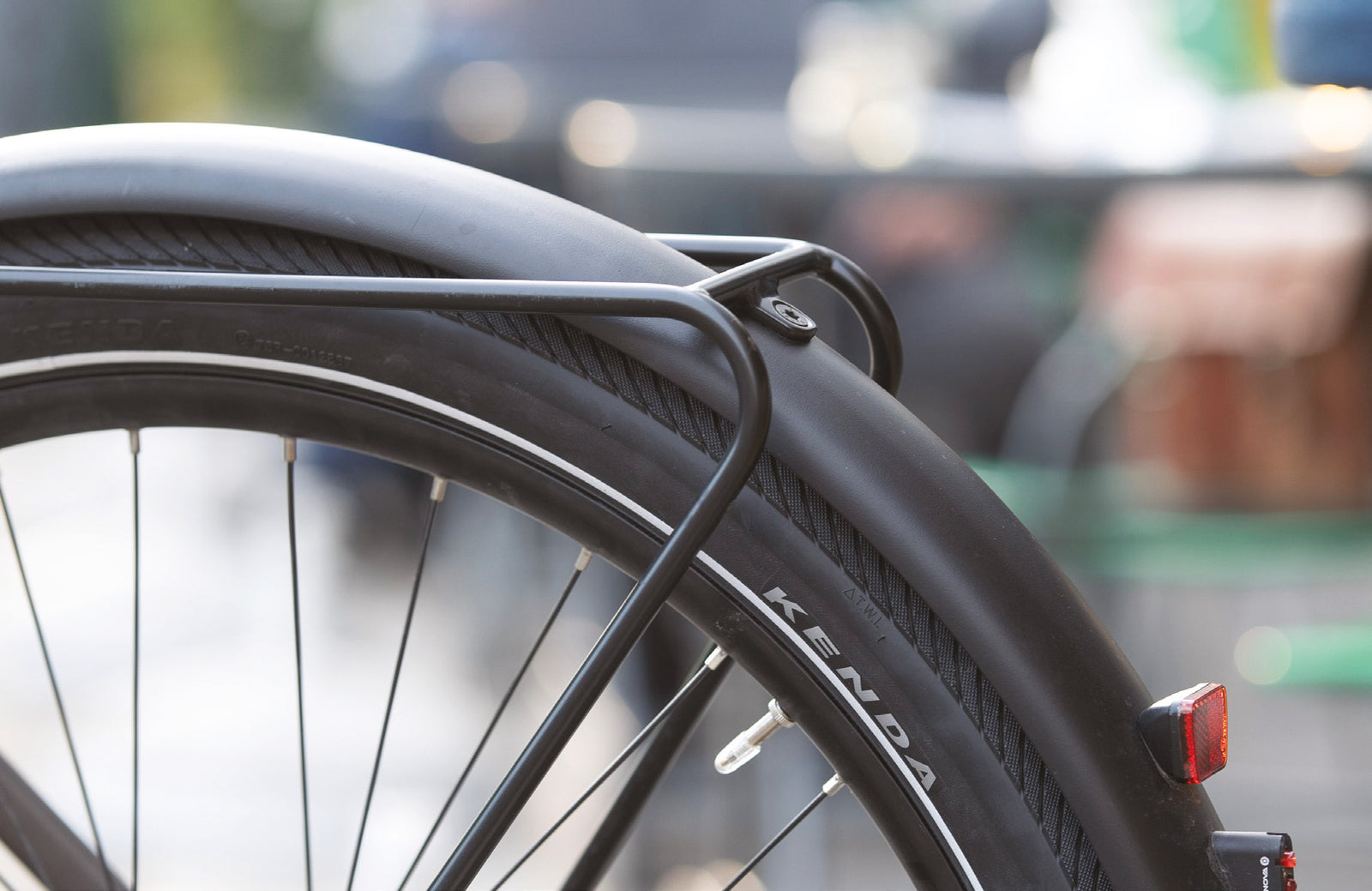 KENDA Commuter tire shown on rear wheel of a bike with fender and taillight