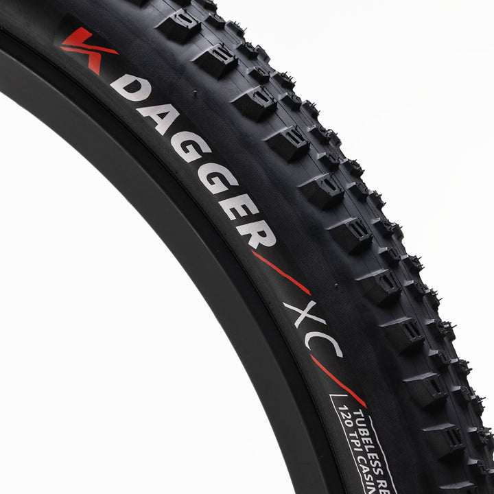 Close-up of a Kenda Dagger XC bicycle tire on a white background