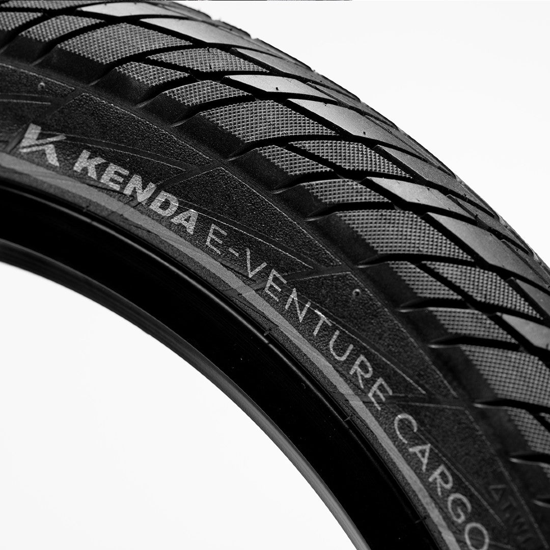 Close-up of a Kenda E-Venture Cargo tire with tread pattern and branding.